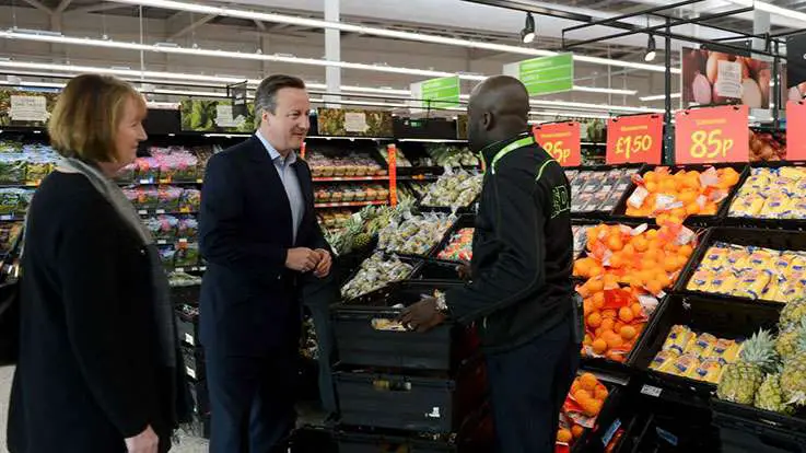 Photo of David Cameron shaking an ASDA workers hand as part of a store visit.