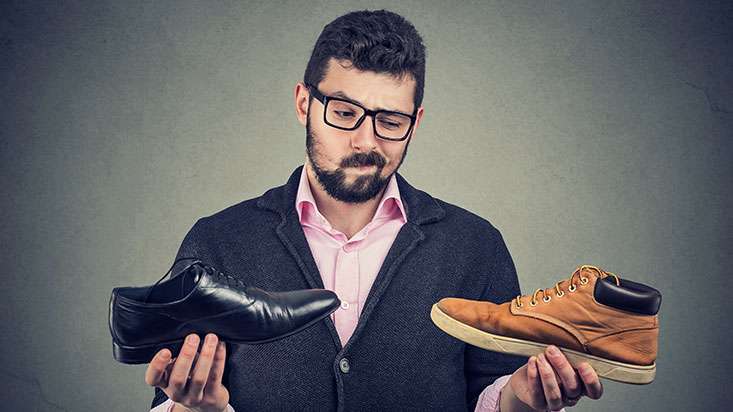 Retail worker trying to choose the right size of shoes