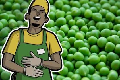 Retail worker laughing in front of peas