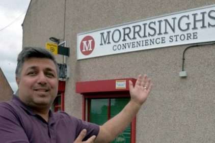 Morrisinghs owner in front of his shop
